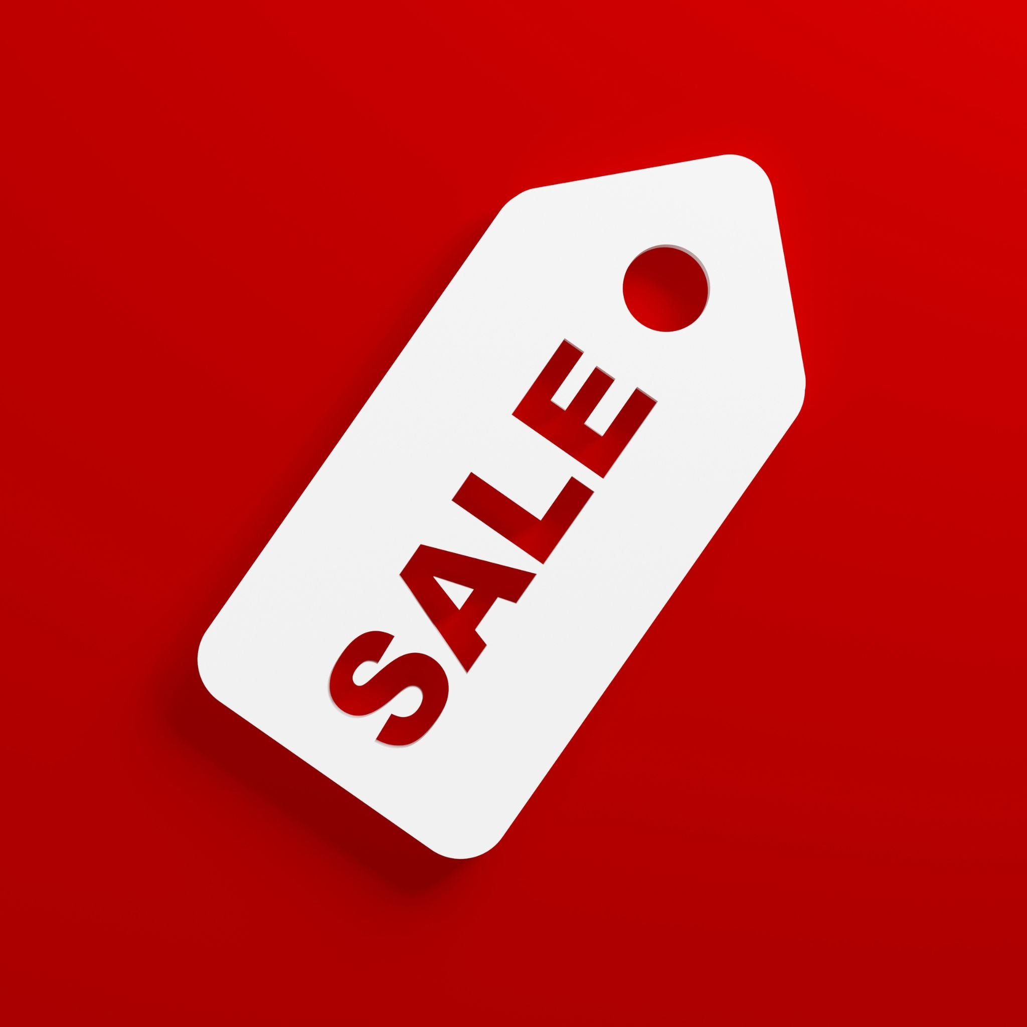 inimalist white sale price tag icon against a bright red background representing discounted action figures and collectibles.