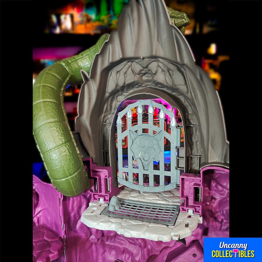 Mattel Masters of the Universe Origins Snake Mountain playset, grey castle with purple accents, snake head at top, wolf head entrance