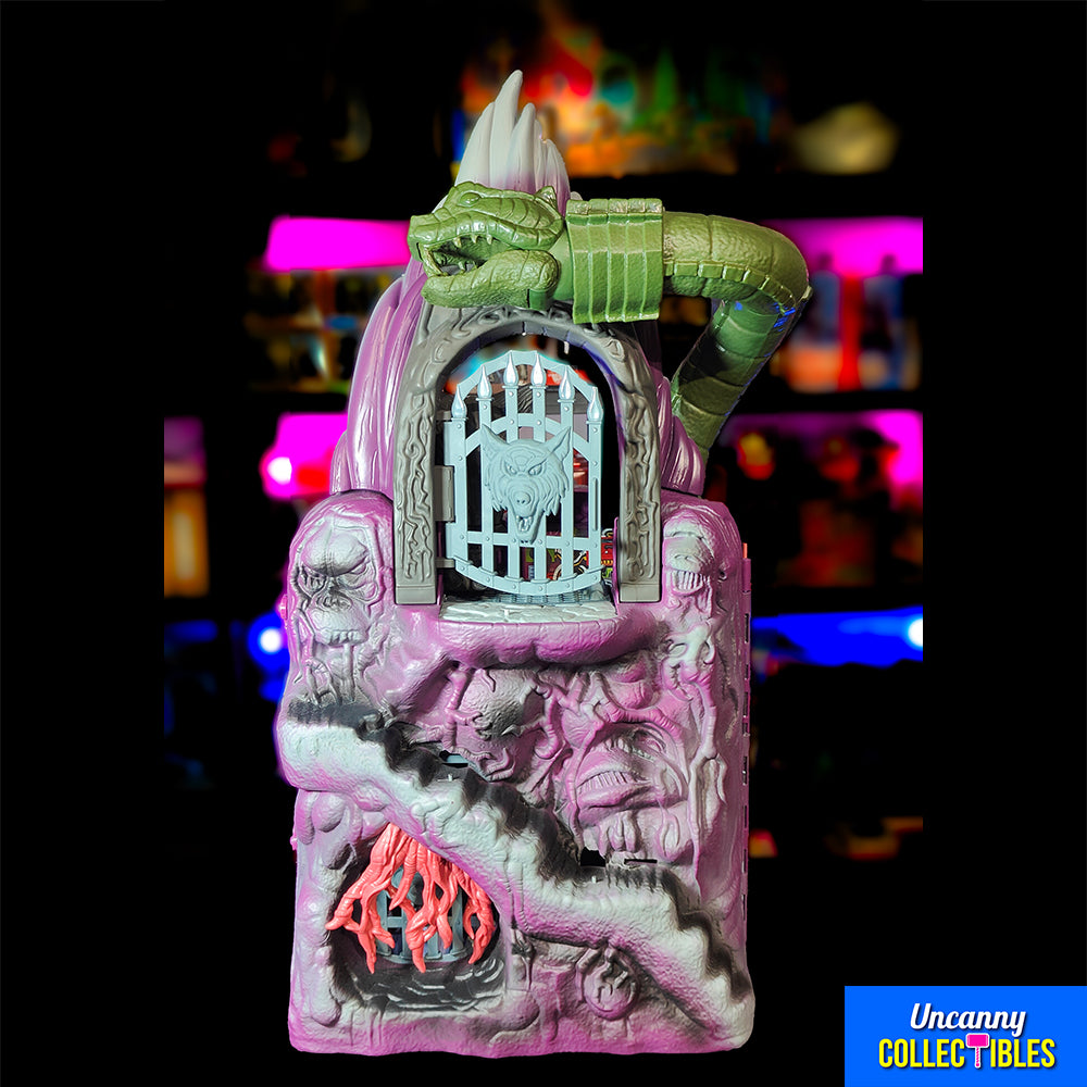 Mattel Masters of the Universe Origins Snake Mountain playset, grey castle with purple accents, snake head at top, wolf head entrance