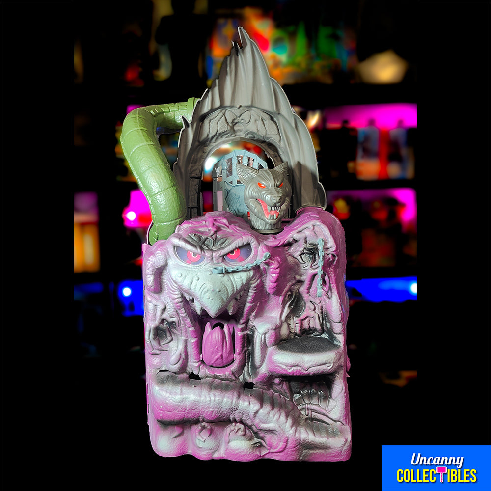 Mattel Masters of the Universe Origins Snake Mountain playset, grey castle with purple accents, snake head at top, wolf head entrance