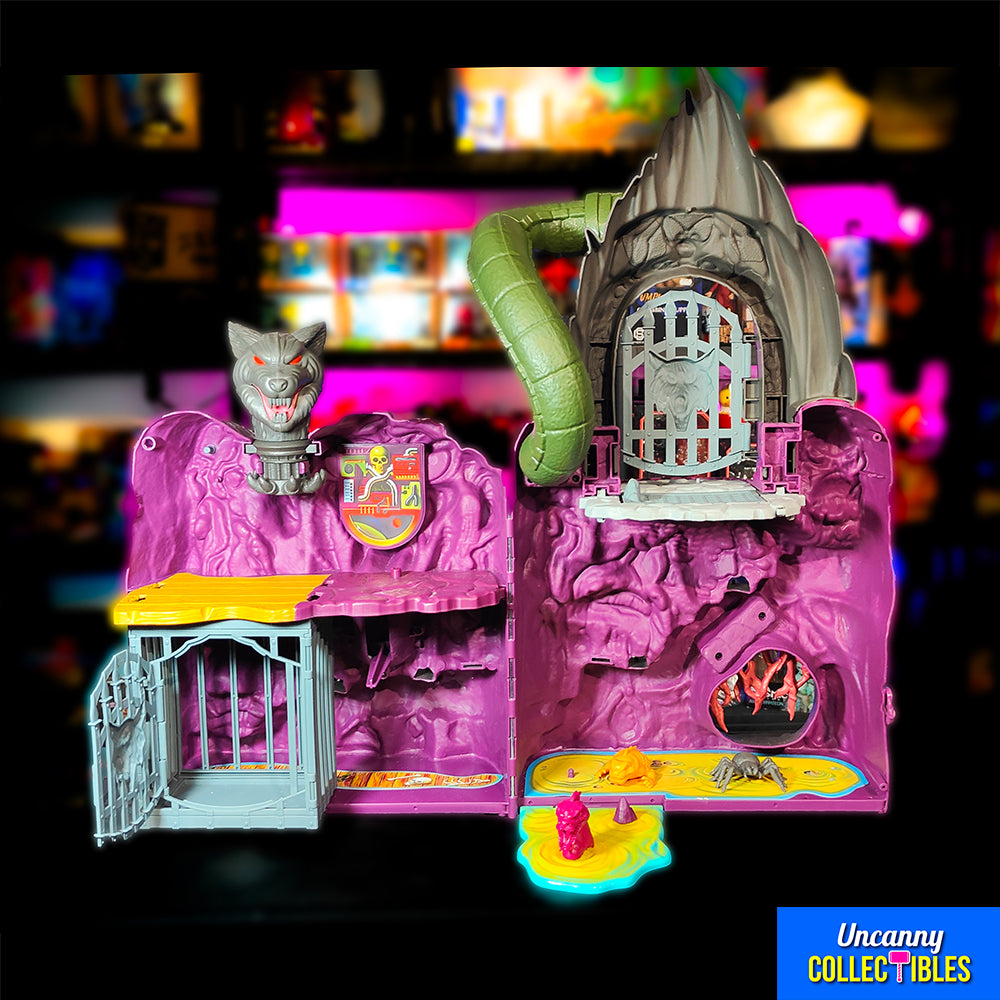 Mattel Masters of the Universe Origins Snake Mountain playset, grey castle with purple accents, snake head at top, wolf head entrance