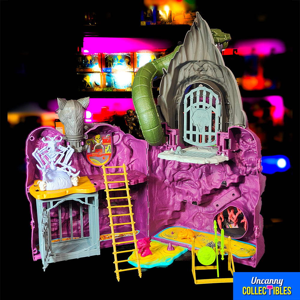 Mattel Masters of the Universe Origins Snake Mountain playset, grey castle with purple accents, snake head at top, wolf head entrance