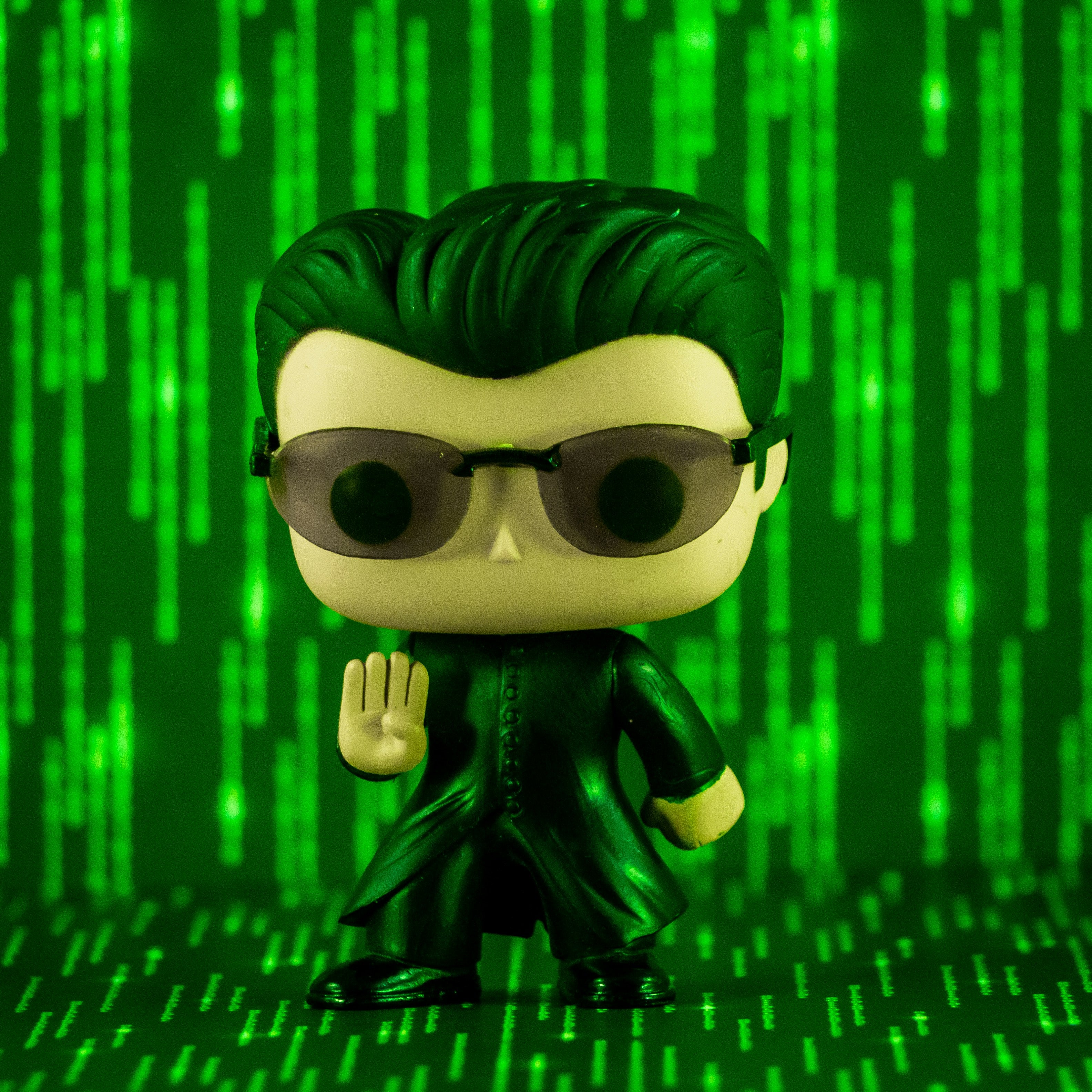 Funko Pop figure of Neo from The Matrix posed in front of a digital green code background, representing the reality check of collectible values.